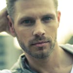 Close-up of a handsome young male model posing outdoors in Hamburg, Germany.